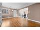 Open-concept living room with access to the kitchen, hardwood flooring, and neutral paint at 536 Detroit St, Denver, CO 80206