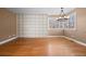 Open living area with wood floors, large built in shelving and modern chandelier at 536 Detroit St, Denver, CO 80206
