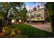 Expansive backyard with lush landscaping, outdoor lighting, and guest house at 165 N High St, Denver, CO 80218