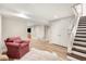 Finished basement featuring chair, stairs, doors, and open entertaining space at 165 N High St, Denver, CO 80218