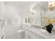 Bright bathroom with a marble countertop, window, black and white tile floor, and an enclosed tile shower at 165 N High St, Denver, CO 80218