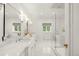Luxurious bathroom with marble countertops, dual sinks, and glass-enclosed shower at 165 N High St, Denver, CO 80218