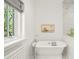 Elegant bathroom with a standalone tub and natural light at 165 N High St, Denver, CO 80218