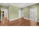 Expansive bedroom features hardwood floors, decorative sconces, and views into other rooms at 165 N High St, Denver, CO 80218