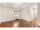 Creamy bedroom with a bright window, hardwood floors, crown molding, and access to another room at 165 N High St, Denver, CO 80218