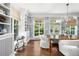 Bright dining room with custom wallpaper, built-in shelving, and large windows overlooking the yard at 165 N High St, Denver, CO 80218