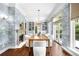 Elegant dining room featuring custom wallpaper, built-in shelving, and ample natural light at 165 N High St, Denver, CO 80218