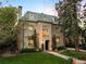 Stunning multi-story home with elegant architecture, manicured lawn, and warm lighting at dusk at 165 N High St, Denver, CO 80218