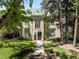 Impressive home with a manicured front yard and stately trees lining the walkway at 165 N High St, Denver, CO 80218