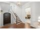Bright foyer with hardwood floors, an elegant staircase, and access to a cozy living space at 165 N High St, Denver, CO 80218