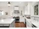Elegant kitchen boasts stainless steel appliances, white cabinetry, and hardwood floors at 165 N High St, Denver, CO 80218