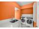 A dedicated laundry room featuring modern washer and dryer, plus sink at 165 N High St, Denver, CO 80218