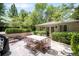 Charming outdoor patio with dining set, lush greenery, and well-maintained landscaping in a serene setting at 165 N High St, Denver, CO 80218