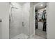 Contemporary bathroom features a glass-enclosed shower and a glimpse into a spacious walk-in closet at 20 Wilcox St # 208, Castle Rock, CO 80104
