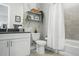 Bright and modern bathroom with stylish fixtures, floating shelves, and shower-tub combination at 20 Wilcox St # 208, Castle Rock, CO 80104