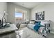 This bedroom has an open balcony, modern desk, nice light, and view of the building's exterior at 20 Wilcox St # 208, Castle Rock, CO 80104