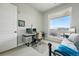 Well-lit bedroom features a balcony, desk, modern lighting, and view of the neighborhood at 20 Wilcox St # 208, Castle Rock, CO 80104