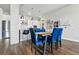 Contemporary dining area with stylish lighting, striking blue chairs, and an open layout to the kitchen at 20 Wilcox St # 208, Castle Rock, CO 80104