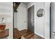 Inviting entryway with dark wood floors, coat rack and a decorative mirror at 20 Wilcox St # 208, Castle Rock, CO 80104