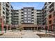 Contemporary condominium complex featuring balconies and a brick entryway with 'Encore' signage at 20 Wilcox St # 208, Castle Rock, CO 80104