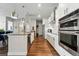 Modern kitchen with stainless steel appliances, sleek white cabinets, and an open design at 20 Wilcox St # 208, Castle Rock, CO 80104