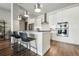 Modern kitchen island with bar seating, stainless steel appliances, and a stylish pendant lighting at 20 Wilcox St # 208, Castle Rock, CO 80104