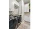 Bright laundry room featuring modern washer, dryer, and ample storage space at 20 Wilcox St # 208, Castle Rock, CO 80104