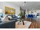 Spacious living room featuring modern decor, a glass coffee table and open concept kitchen at 20 Wilcox St # 208, Castle Rock, CO 80104