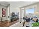 Bright living room featuring wood floors, a large window, a view, and modern decor at 20 Wilcox St # 208, Castle Rock, CO 80104