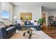 Cozy living room with a leather sofa, glass table, and an art piece on the wall at 20 Wilcox St # 208, Castle Rock, CO 80104