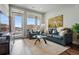 Comfortable living room with a leather sofa, glass table, and balcony access at 20 Wilcox St # 208, Castle Rock, CO 80104
