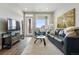Well-lit living room with a leather sofa, glass table, and balcony access at 20 Wilcox St # 208, Castle Rock, CO 80104