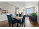 Open-concept living space featuring a modern dining table, comfortable seating, and natural light at 20 Wilcox St # 208, Castle Rock, CO 80104