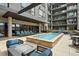 Outdoor pool area with fire pit and grill, lounge seating, and community spa at 20 Wilcox St # 208, Castle Rock, CO 80104