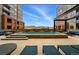 Relaxing pool area surrounded by residential buildings, with sun loungers and seating at 20 Wilcox St # 208, Castle Rock, CO 80104