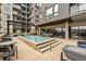 Outdoor pool deck with lounge chairs, dining tables and community spa at 20 Wilcox St # 208, Castle Rock, CO 80104