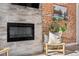 Living room with a brick accent wall and fireplace at 1725 E Martin Luther King Jr Blvd, Denver, CO 80205