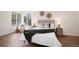 Cozy bedroom featuring a large window, hardwood floors, and modern decor at 8422 Everett Way # D, Arvada, CO 80005