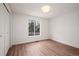 Bedroom featuring hardwood floors, a window, and a closet at 8422 Everett Way # D, Arvada, CO 80005