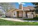 Charming home featuring stone accents on the chimney and porch with a well-maintained lawn and landscaped surroundings at 8422 Everett Way # D, Arvada, CO 80005