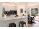 Open kitchen with sleek bar seating, modern appliances, and contemporary finishes, ideal for culinary enthusiasts and entertaining guests at 8422 Everett Way # D, Arvada, CO 80005
