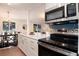 Kitchen features a stainless steel microwave and oven, and a white countertop island at 8422 Everett Way # D, Arvada, CO 80005