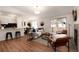 Bright living room featuring wood floors, modern furnishings, and access to the outdoors through sliding glass doors at 8422 Everett Way # D, Arvada, CO 80005