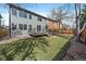 Spacious backyard with grassy lawn, wooden fence, and a deck at 5586 S Harlan St, Littleton, CO 80123