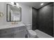 Chic bathroom with black shower tiles, square mirror, and modern vanity at 5586 S Harlan St, Littleton, CO 80123