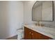 Stylish powder room with marble countertop, wood vanity, and modern fixtures at 5586 S Harlan St, Littleton, CO 80123