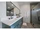 Elegant bathroom features double sinks, sleek mirror, and glass-enclosed shower at 5586 S Harlan St, Littleton, CO 80123
