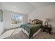 Cozy bedroom with large window, neutral carpet, and comfortable bed at 5586 S Harlan St, Littleton, CO 80123