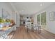 A dining room that leads to the kitchen with access to an outdoor patio through sliding glass doors at 5586 S Harlan St, Littleton, CO 80123
