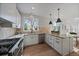 Modern kitchen featuring stainless steel appliances, granite counters, and ample cabinet space at 5586 S Harlan St, Littleton, CO 80123